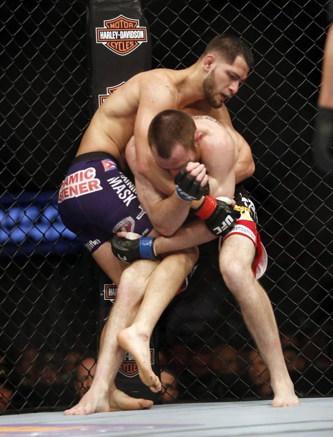 Jorge Masvidal, top, and Pat Healy fight in a mixed martial arts event on Saturday, April 19, 2014, at UFC Fight Night in Orlando, Fla. Masvidal won.