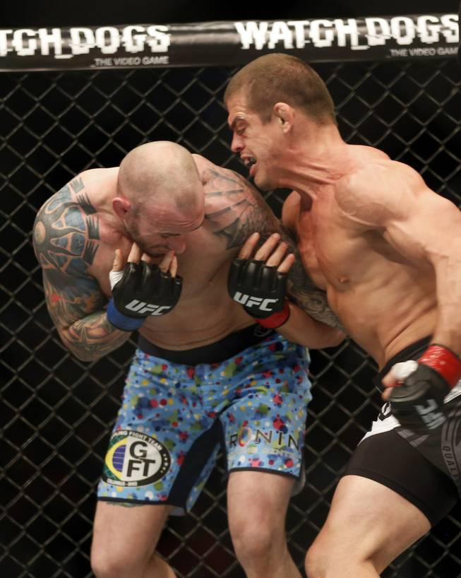 Luke Zachrich, left, and Caio Magalhaes of Brazil fight in a mixed martial arts event on Saturday, April 19, 2014, at UFC Fight Night in Orlando, Fla. Magalhaes won.
