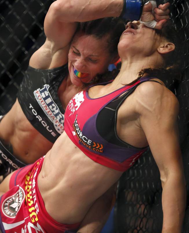 Miesha Tate, right, and Liz Carmouche fight in a mixed martial arts event on Saturday, April 19, 2014, at UFC Fight Night in Orlando, Fla. Tate defeated Carmouche.