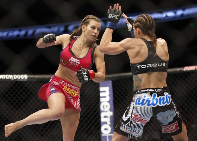 Miesha Tate, left, and Liz Carmouche fight in a mixed martial arts event on Saturday, April 19, 2014, at UFC Fight Night in Orlando, Fla. Tate defeated Carmouche.