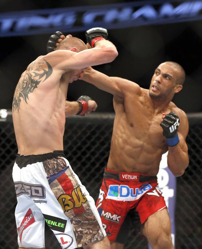 Donald Cerrone, left, and Edson Barboza, of Brazil, fight in a mixed martial arts event on Saturday, April 19, 2014, at UFC Fight Night in Orlando, Fla. Cerrone won by tap out.