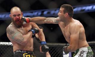 Fabricio Werdum, right, hits Travis Browne during a UFC mixed martial arts bout on Saturday, April 19, 2014, in Orlando, Fla. Werdum won.