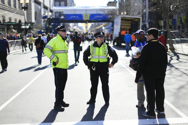 Police stand by near the finish line ahead of Monday's 118th Boston Marathon on April 20 in Boston. Massachusetts Gov. Deval Patrick says officials are striking a balance between more security and maintaining the city's festive spirit.