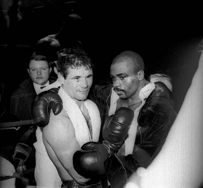 In this Feb. 23, 1965, file photo, Rubin "Hurricane" Carter and Italian boxer Fabio Bettini pose after a fight at the Palais des Sports in Paris. Carter, who spent almost 20 years in jail after twice being convicted of a triple murder he denied committing, died at his home in Toronto, Sunday, April 20, 2014, according to long-time friend and co-accused John Artis. He was 76.