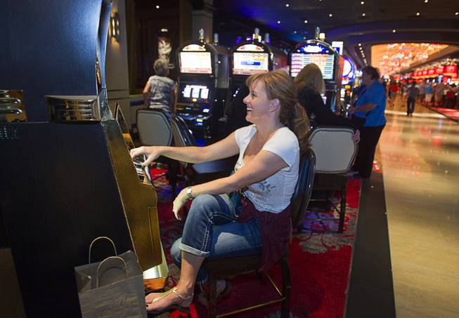 Alia Gettler of San Ramon, Calif. plays slots during the opening of the casino floor at the Cromwell, formerly Bill's Gamblin' Hall & Saloon, on the Las Vegas Strip and Flamingo Avenue, Monday, April 21, 2014. The casino is undergoing a $185 million renovation project that includes remodeling of guest rooms, casino floor and common areas, the addition of a new second floor restaurant, and construction of the 65,000 square foot rooftop pool and dayclub/nightclub.