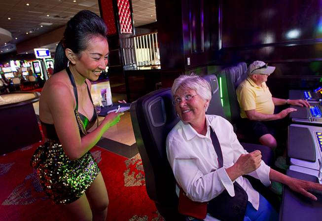 Beverage concierge Naphatsawan "Belle" McCabe takes a drink order during the opening of the casino floor at the Cromwell, formerly Bill's Gamblin' Hall & Saloon, on the Las Vegas Strip and Flamingo Avenue, Monday, April 21, 2014. The casino is undergoing a $185 million renovation project that includes remodeling of guest rooms, casino floor and common areas, the addition of a new second floor restaurant, and construction of the 65,000 square foot rooftop pool and dayclub/nightclub.