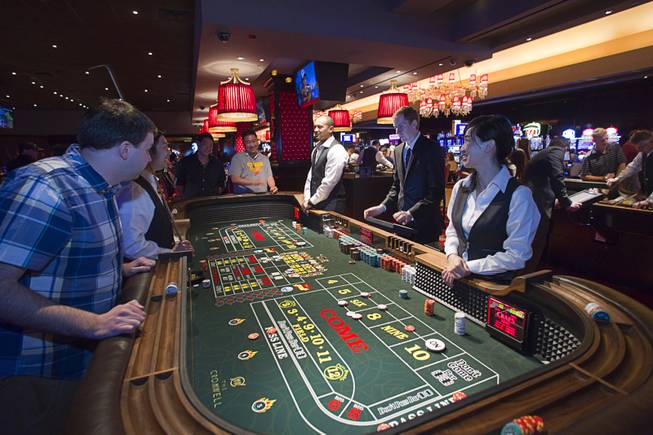 Gamblers play craps during the opening of the casino floor at the Cromwell, formerly Bill's Gamblin' Hall & Saloon, on the Las Vegas Strip and Flamingo Avenue, Monday, April 21, 2014. The casino is undergoing a $185 million renovation project that includes remodeling of guest rooms, casino floor and common areas, the addition of a new second floor restaurant, and construction of the 65,000 square foot rooftop pool and dayclub/nightclub.