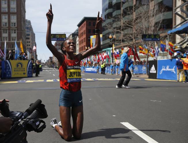 Rita Jeptoo, of Kenya, celebrates her win in the women's division of the 118th Boston Marathon Monday, April 21, 2014 in Boston. 