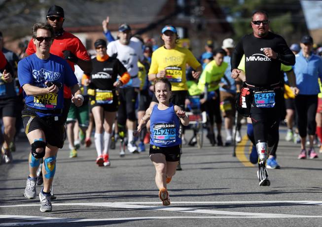 Mobility-impared runners David Abel, left, Juli Windsor, and Scott Rigsby compete in the 118th Boston Marathon Monday, April 21, 2014, in Hopkinton, Mass.