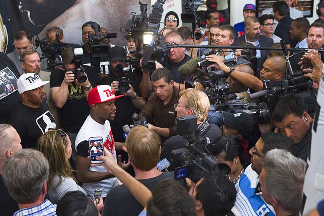WBC welterweight champion Floyd Mayweather Jr. is surrounded by reporters before a media workout at the Mayweather Boxing Club Tuesday, April 22, 2014. Mayweather is preparing for his fight against WBA champion Marcos Maidana of Argentina at the MGM Grand Garden Arena on May 3.
