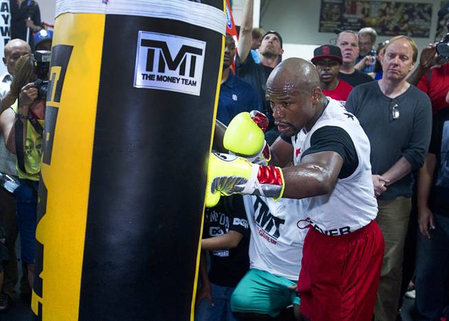 WBC welterweight champion Floyd Mayweather Jr. hits a heavy bag during a media workout at the Mayweather Boxing Club Tuesday, April 22, 2014. Mayweather is preparing for his fight against WBA champion Marcos Maidana of Argentina at the MGM Grand Garden Arena on May 3.