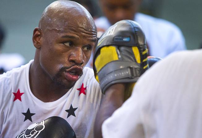 WBC welterweight champion Floyd Mayweather Jr. (L) of the U.S. works on his timing at the Mayweather Boxing Club Tuesday, April 22, 2014. Mayweather is preparing for his fight against WBA champion Marcos Maidana of Argentina at the MGM Grand Garden Arena on May 3.