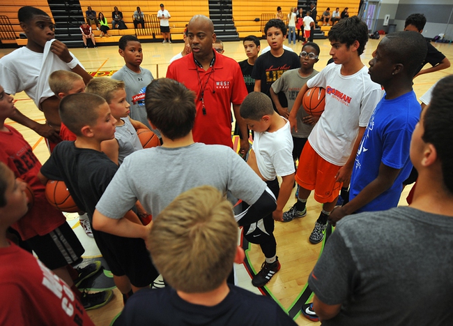 Former UNLV Runnin' Rebels point guard Dedan Thomas, center, instructs members of his youth team during a practice session held at Western Tech High School on Tuesday, April 22, 2014.