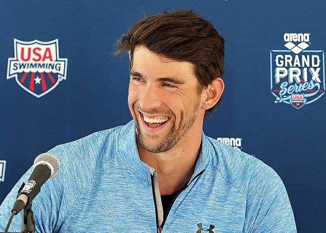 Michael Phelps speaks to the media after practice, Wednesday, April 23, 2014, in Mesa, Ariz. Phelps is competing in the Arena Grand Prix at Mesa on Thursday as he returns to competitive swimming after a nearly two-year retirement. 