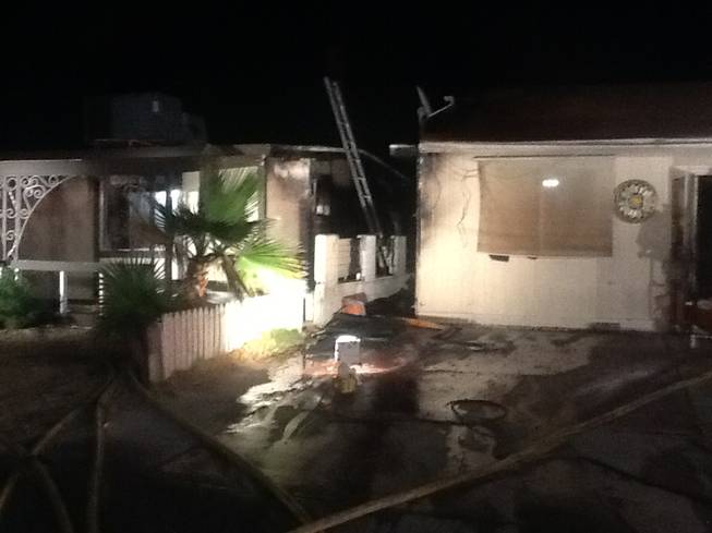 Las Vegas Fire & Rescue crews extinguished a fire that started between these two homes at 416 and 420 Princeton St. early Wednesday, April 23, 2014. Combined damage was estimated at $50,000.