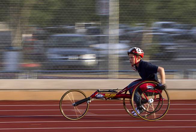 Blake Dickinson, 11, a sixth grader at Cadwallader Middle School student, practices with his trike on the track during a Paralympic Sports Night at Rancho High School Wednesday, April 23, 2014.