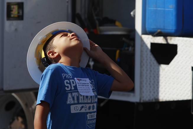 Meki Salima watches as a line truck raises its basket during "Take Our Daughters and Sons to Work Day" at NV Energy Thursday, April 24, 2014.
