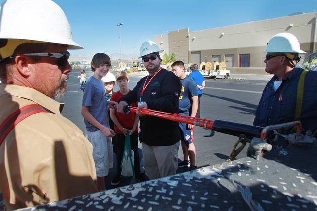 Derek Graff demonstrates equipment to Julian Stenroos during "Take Our Daughters and Sons to Work Day" at NV Energy Thursday, April 24, 2014.
