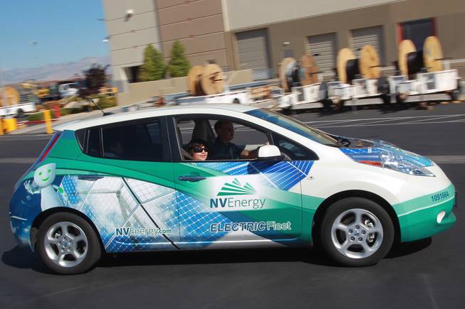 Gregg Parlade gets a ride in an electric car during "Take Our Daughters and Sons to Work Day" at NV Energy Thursday, April 24, 2014.