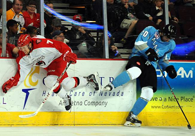 Wranglers forward Chris Kushneriuk (7) is checked against the boards by Alaska Aces defenseman Corey Syvret during the second period of an ECHL playoff game on Friday night at the Orleans Arena.