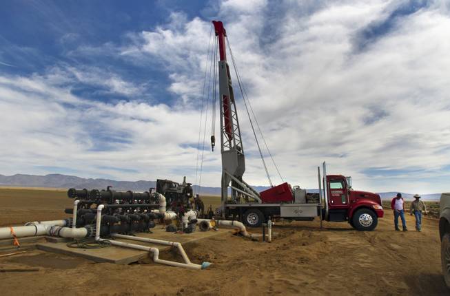A well-drilling crew works to tap into the water table at the new Kingman Farms owned by Las Vegas developer Jim Rhodes outside Kingman, Ariz., on Wednesday, April 9, 2014.