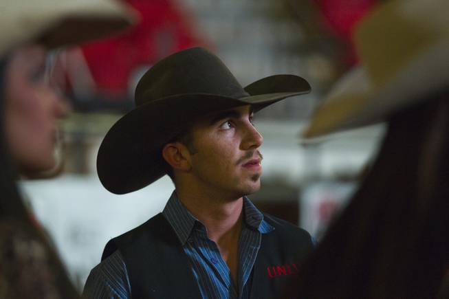 UNLV rodeo competitor Tyler Baeza stands with teammates during the start of the West Coast Regional Finals Rodeo at South Point Arena on Friday, April 25, 2014.