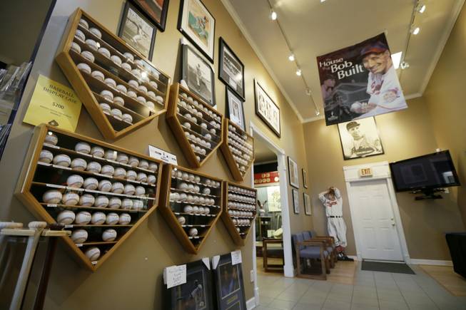 Autographed baseballs and photographs are displayed at the Bob Feller Museum, Friday, April 11, 2014, in Van Meter, Iowa. Just three years after the death of the "Heater from Van Meter," the museum built in 1995 to honor the former Indians star finds itself gasping for life. 