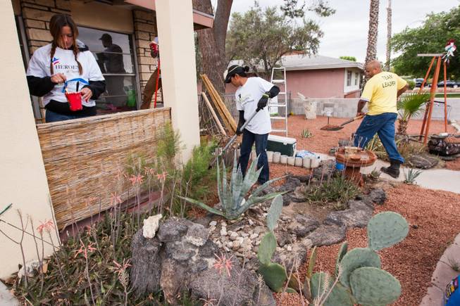 Volunteers work on the desert landscaping in the front yard of the home of photographer Robert Scott Hooper and wife Theresa Hooper as part of the Rebuilding Together Southern Nevada's annual neighborhood rebuilding event in Las Vegas Saturday, April 26, 2014.