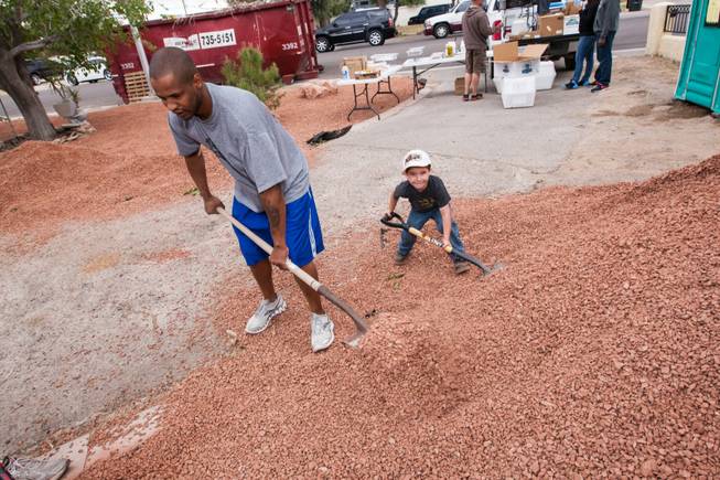 Four-year-old Everett Blower shovels rocks with other volunteers while working at the home of photographer Robert Scott Hooper and wife Theresa Hooper as part of the Rebuilding Together Southern Nevada's annual neighborhood rebuilding event in Las Vegas Saturday, April 26, 2014.