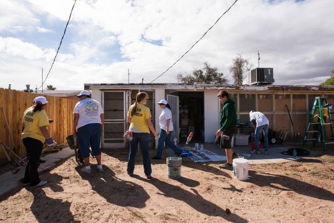 Volunteers work in the backyard of the home of former magician Gary Darwin, who lost his leg to diabetes, as part of the Rebuilding Together Southern Nevada's annual neighborhood rebuilding event in Las Vegas Saturday, April 26, 2014.