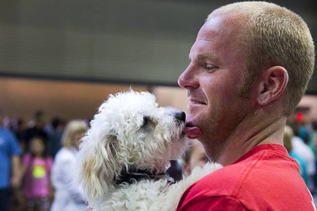 Travis Davis gets kiss from Turbo during the Animal Foundation's 11th annual Best in Show at the Orleans Arena Sunday, April 27, 2014. Davis provided a foster home for Turbo before the show and was given the first option on adopting the dog.