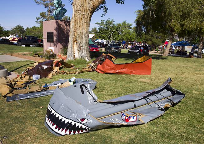 The remains of cardboard boats used in the Cardboard Regatta are shown by the pond during the second annual Pirate Festival Las Vegas in Lorenzi Park Sunday, April 27, 2014.