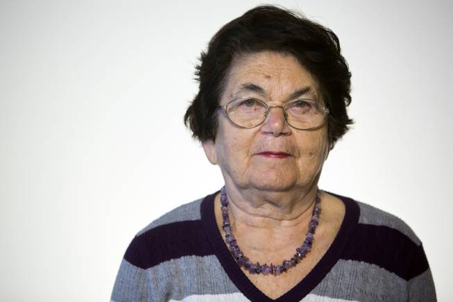 Israeli Holocaust survivor Ester Koffler Paul, 82, originally from what is now Ukraine, poses for a portrait in Jerusalem. Paul was 8, and her sister Nunia was 10 in 1941 when the Nazis invaded their hometown of Buchach in what is now Ukraine. Their mother died before the war and their father was taken by the Nazis and murdered along with 700 other Jewish men.