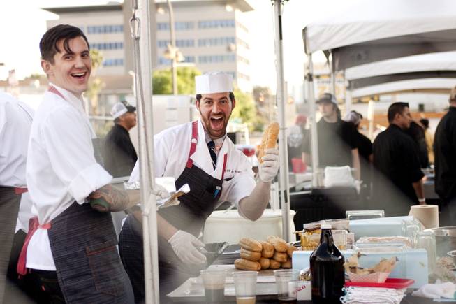Cooks at one of the food stands pose for a photo during the "Great Vegas Festival of Beer" gathering on Fremont East Entertainment District Saturday, April 26, 2014.