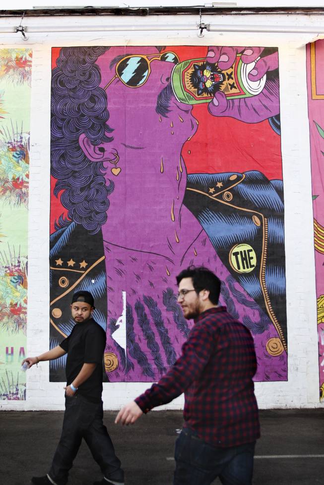 Featival goers walk past a mural dedicated to The Killers that emulates the night's festivities during the "Great Vegas Festival of Beer" gathering on Fremont East Entertainment District Saturday, April 26, 2014.