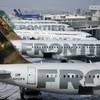 In this Feb. 22, 2010, file photo, Frontier Airlines jetliners sit stacked up at gates along the A concourse at Denver International Airport.