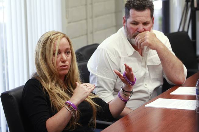 Kyle Bryan listens while Aimee Hairr talks about the lawsuit filed by the ACLU on their behalf against Clark County school officials Tuesday, April 29, 2014.