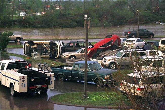 Tornado damaged automobiles clutter the parking lot of the Winston Medical Center in Louisville, Miss., Monday, April 28, 2014. The facility, its parking lot and a neighboring nursing home were among the properties heavily damaged by a tornado. 