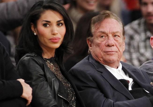 In this Dec. 19, 2010, file photo, V. Stiviano and Los Angeles Clippers owner Donald Sterling watch the Clippers play the Los Angeles Lakers during an NBA preseason game in Los Angeles.