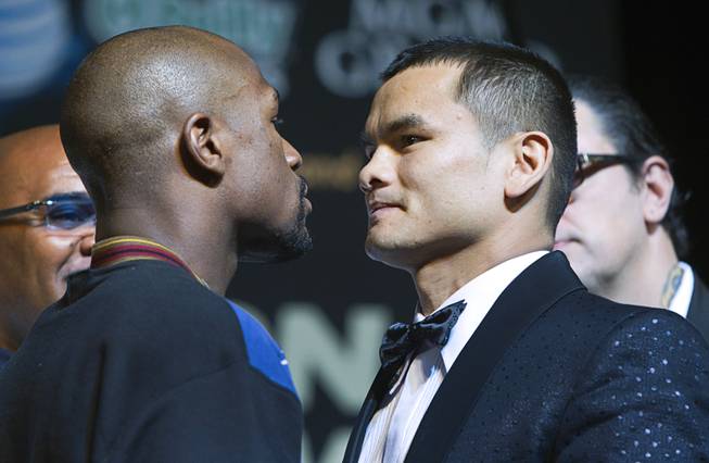 WBC welterweight champion Floyd Mayweather Jr. and WBA champion Marcos Maidana of Argentina face off during a news conference at MGM Grand on Wednesday, April 30, 2014. The two champions will meet in a WBC/WBA unification fight at MGM Grand Garden Arena on Saturday.
