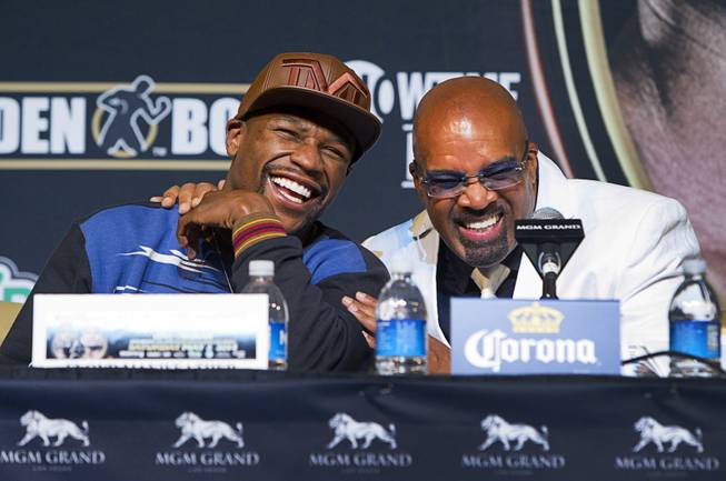 WBC welterweight champion Floyd Mayweather Jr. (L) laughs with Mayweather Promotions CEO Leonard Ellerbe during a news conference at the MGM Grand Wednesday, April 30, 2014. Mayweather will take on WBA welterweight champion Marcos Maidana of Argentina in a WBC/WBA unification fight at the MGM Grand Garden Arena on Saturday.