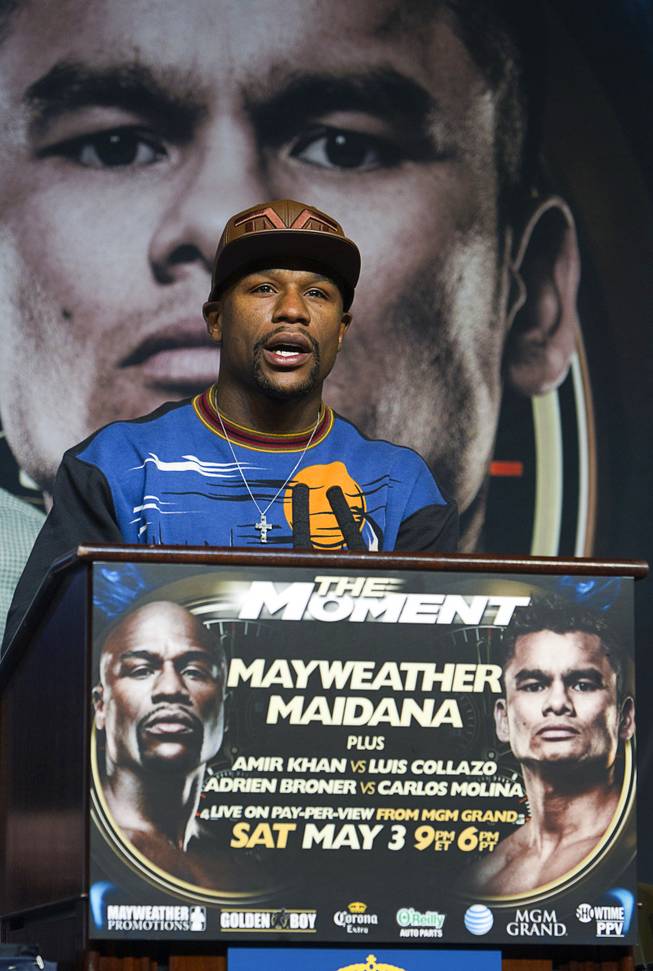 WBC welterweight champion Floyd Mayweather Jr. speaks in front of a banner with the image of opponent Marcos Maidana during a news conference at the MGM Grand Wednesday, April 30, 2014. Mayweather will take on WBA welterweight champion Marcos Maidana of Argentina in a WBC/WBA unification fight at the MGM Grand Garden Arena on Saturday.