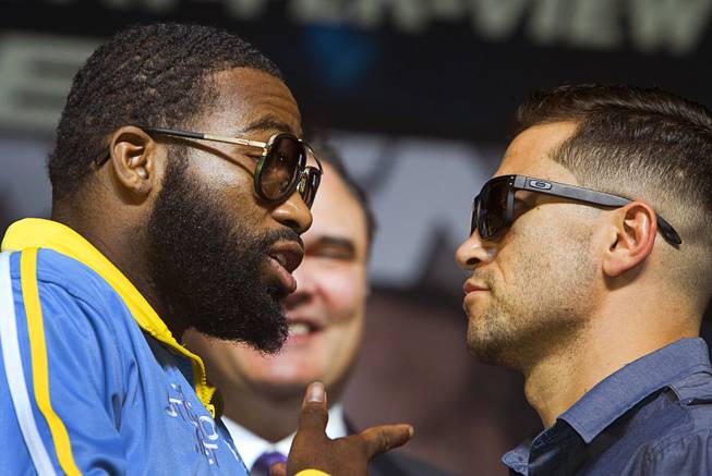 Super lightweight boxer Adrien Broner left  speaks with opponent Carlos Molina as they face off during a news conference for undercard boxers at the MGM Grand Thursday, May 1, 2014. The boxers will fight at the MGM Grand Garden Arena on Saturday.