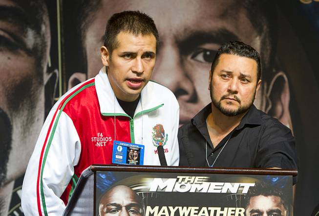 Super middleweight boxer Marcos Periban, left, of Mexico speaks at a news conference for undercard boxers at the MGM Grand Thursday, May 1, 2014. Periban will fight J'Leon Love at the MGM Grand Garden Arena on Saturday.