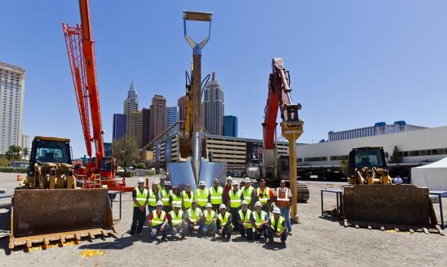Members of Thor Construction pose before a giant shovel following the AEG and MGM Resorts International ground breaking for a new world-class indoor arena in Las Vegas on Thursday, May 1, 2014.  The 20,000-seat sports and entertainment venue will be located near the heart of the famed Las Vegas Strip and adjacent to the I-15 corridor.