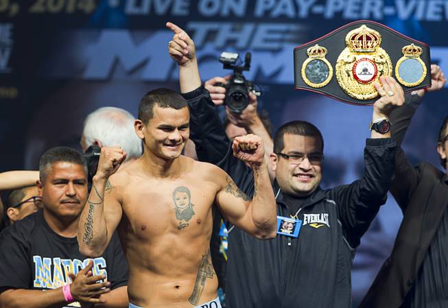 WBA welterweight champion Marcos Maidana of Argentina poses on the scale during an official weigh-in at the MGM Grand Garden Arena Friday, May 2, 2014. Maidana faces undefeated WBC welterweight champion Floyd Mayweather Jr.  in a WBC/WBA unification fight at the arena on Saturday.