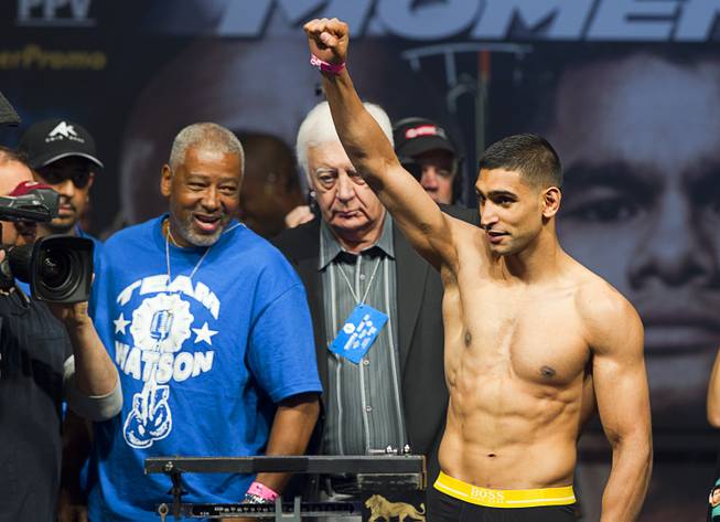 Amir Khan of Britain acknowledges fans during an official weigh-in at the MGM Grand Garden Arena Friday, May 2, 2014. Khan will face Luis Collazo  for a welterweight fight at the arena on Saturday.