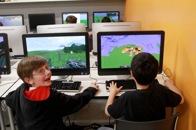 Bobby Craig, left, and Doogy Lee create worlds in "Minecraft" that parallel what they have been reading in "The Hobbit" as part of their fifth grade class studies at Quest Academy in Palatine, Ill.