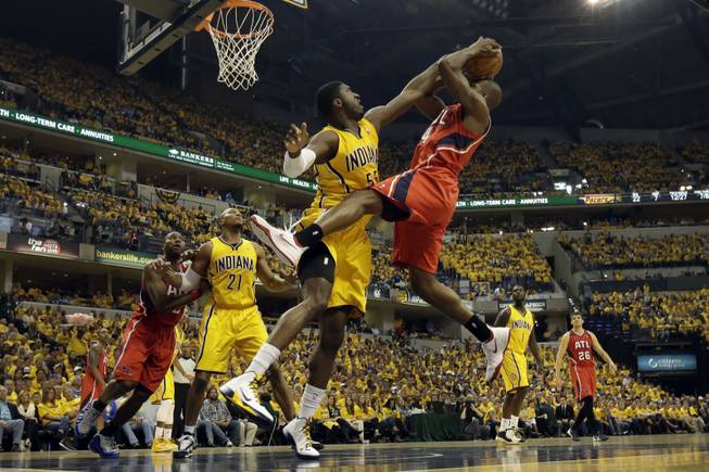 Indiana Pacers center Roy Hibbert, front left, tries to block the shot of Atlanta Hawks forward Paul Millsap during the first half in Game 7 of a first-round NBA basketball playoff series in Indianapolis, Saturday, May 3, 2014.