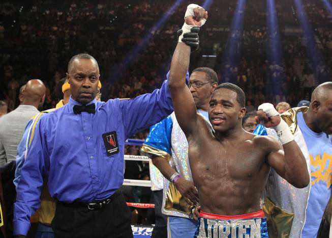 Adrien Broner of the U.S. celebrates his victory over Carlos Molina in their super lightweight fight at the MGM Grand Garden Arena on Saturday, May 3, 2014. Boxing Referee Kenny Bayless is at left.